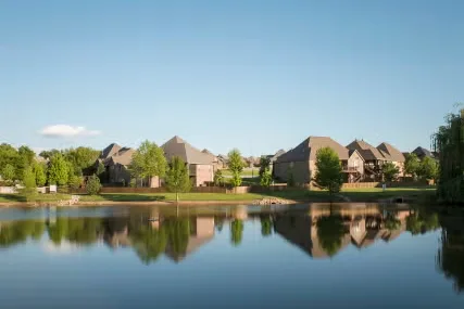 Homes reflected in a calm pond in Nixa, MO